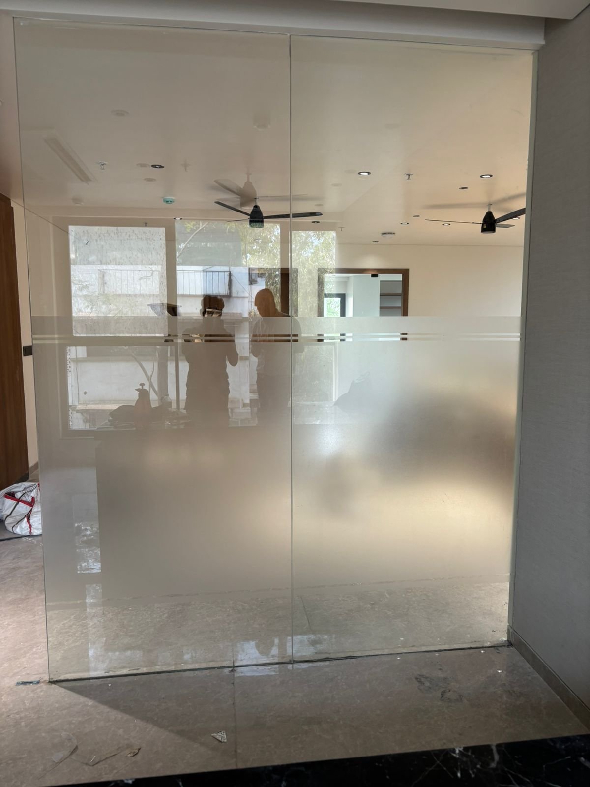 Full glass partition with frosted lower privacy film