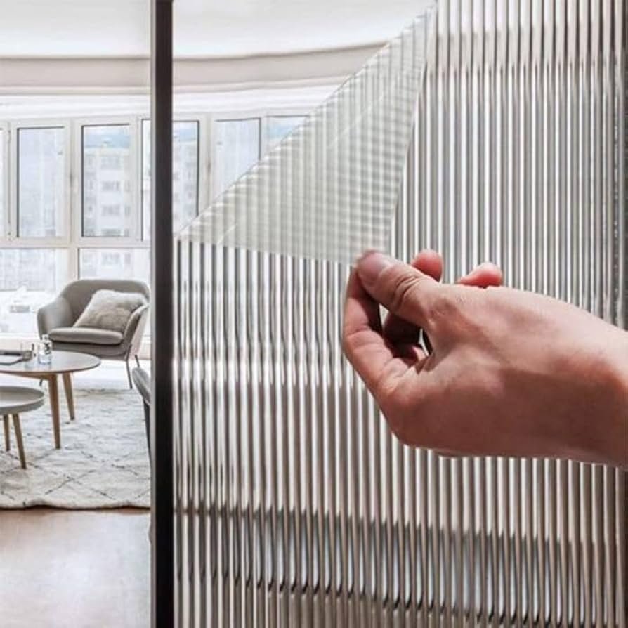 Peel and stick ribbed window film being applied